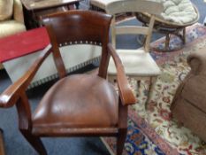 An antique dining chair and a mahogany chair
