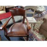 An antique dining chair and a mahogany chair