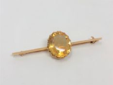 A 15ct gold bar brooch set with a large citrine CONDITION REPORT: 3.