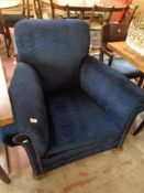 An antique re-upholstered armchair in blue fabric