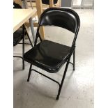 Five folding metal chairs