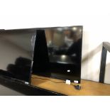 A Samsung 40" LCD TV (wall mounted no stand) and remote