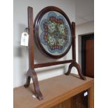 A mahogany framed tapestry screen