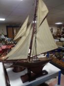 A vintage wooden pond yacht on stand CONDITION REPORT: Approximately 96cm long by