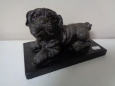 A bronze figure of a Pekingese on black marble plinth