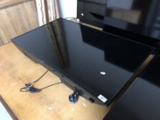A Samsung 40" LCD TV (wall mounted no stand)