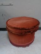 A circular footstool