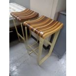 A good quality pair of mixed wood bar stools on painted metal bases