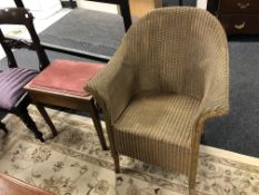 A gold loom armchair and piano stool