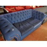 A contemporary stitched blue upholstered Chesterfield style two seater settee