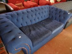 A contemporary stitched blue upholstered Chesterfield style two seater settee