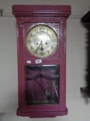 An early twentieth century painted wall clock with silvered dial,