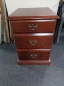 A mahogany effect three drawer chest