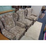 Three upholstered armchairs in floral fabric