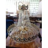An impressive crystal drop gilt metal chandelier