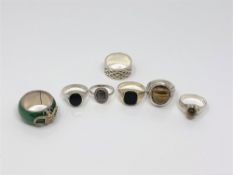 Five silver stone set rings,