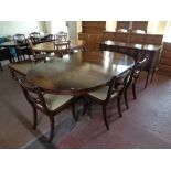 A Regency style inlaid mahogany circular pedestal dining table with leaf together with a set of six