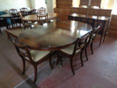 A Regency style inlaid mahogany circular pedestal dining table with leaf together with a set of six