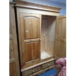 A pine double door wardrobe with two drawers