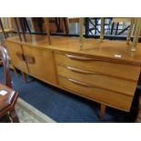 A mid century teak bow-fronted sideboard