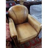 An antique style tan leather armchair