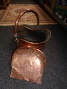 An antique copper coal helmet and copper scoup