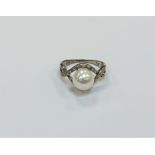 A silver pearl dress ring,
