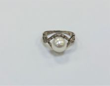 A silver pearl dress ring,