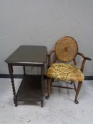 An Edwardian occasional table and a bergere backed armchair