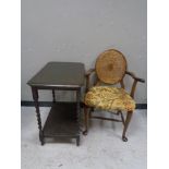 An Edwardian occasional table and a bergere backed armchair