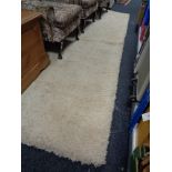 A large piece of shaggy pile carpet in cream
