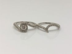 Two 18ct white gold diamond set rings - Brilliant cut four claw diamond mounted in a swirl of