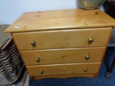 A pine three drawer chest