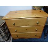 A pine three drawer chest