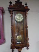 A Victorian mahogany wall clock with enamelled dial and pendulum