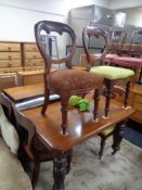A Victorian mahogany extending table with two leaves and a harlequin set of six dining chairs