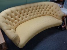 A Victorian curved two seater buttoned settee