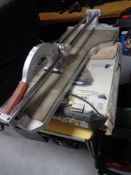 A wet tile saw and a further tile cutter