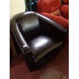 A brown stitched leather tub chair