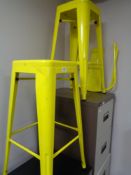 Two yellow metal bar stools with disconnected backs