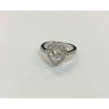A silver heart shaped dress ring,