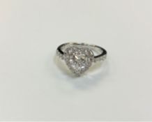 A silver heart shaped dress ring,