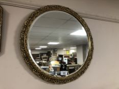 A circular gilt framed mirror