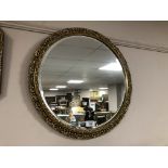 A circular gilt framed mirror