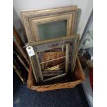 A wicker crate of antique and later picture frames and a large piece of glass