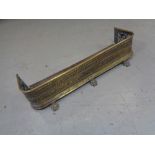 A Victorian brass fire fender