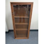 A stained plywood glazed door bookcase