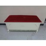 A blanket box with red dralon seat