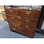 A George III mahogany five drawer chest with brass drop handles on bracket feet