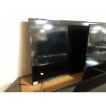 A Samsung 40" LCD TV (wall mounted no stand)